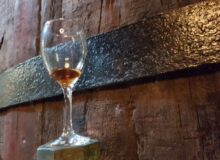 Museum_Of_Samos_Wine_1_Glass_against_barrel
