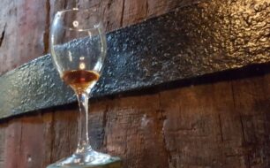 Museum_Of_Samos_Wine_1_Glass_against_barrel