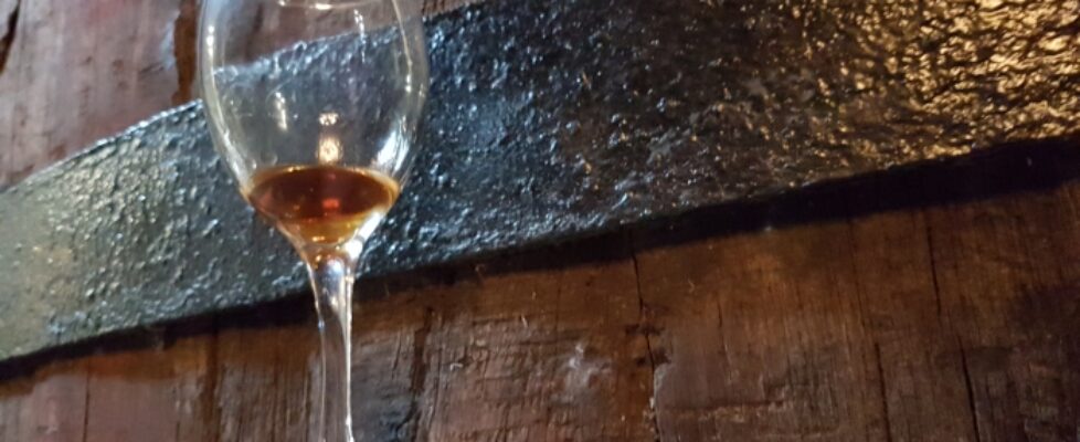 Museum_Of_Samos_Wine_1_Glass_against_barrel